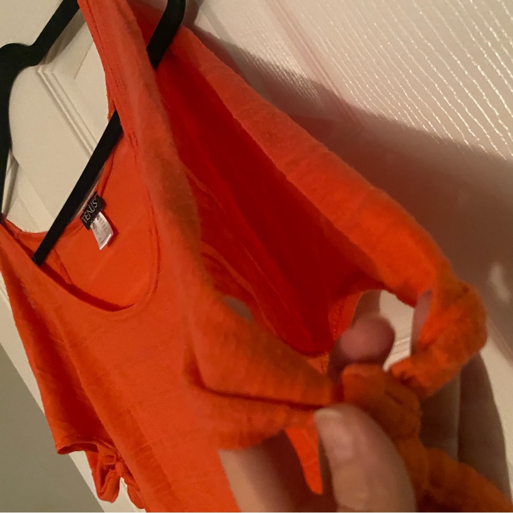 orange short sleeve shirt .